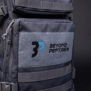 Close-up of the embroidered Beyond Peptides logo on the grey front pocket panel