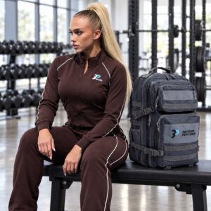 Beyond Peptides Gym Backpack on a weight bench beside an athlete in the brown tracksuit