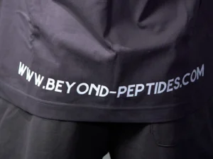 Close-up of the double-stitched hem and the web address print on the back of the Grey Oversized Tee