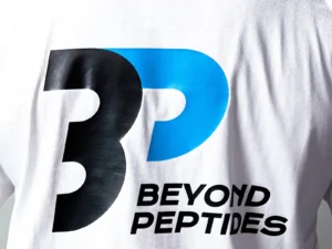 Close-up of the large Beyond Peptides print on the back of the White Oversized Tee